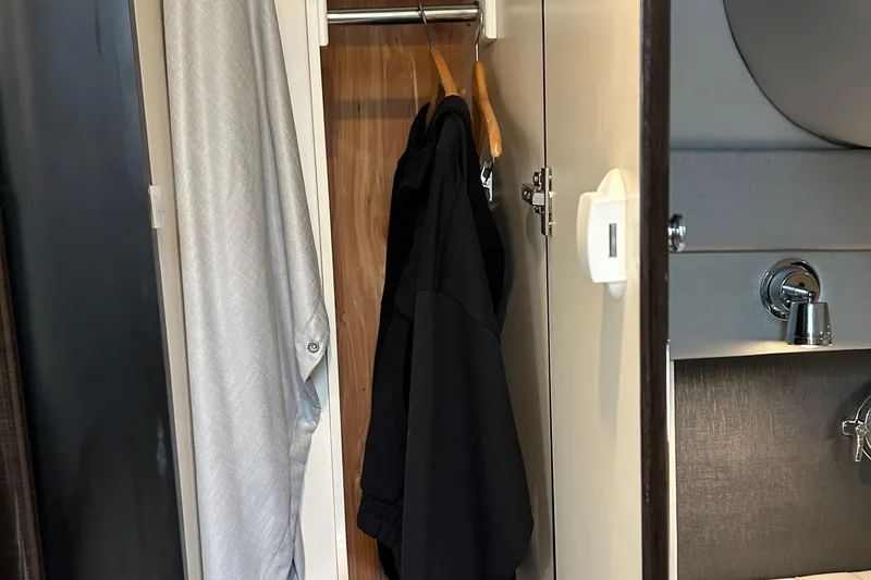 Slide: The Image of 2016 Formula 40 Cruiser interior closet with hanging clothes and adjacent sink. - 46
