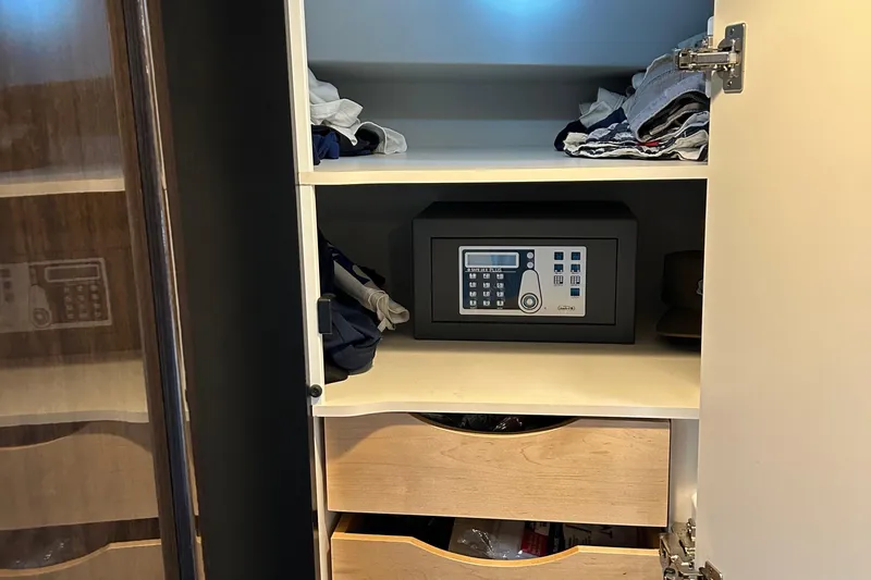 Slide: The Image of Cabinet with electronic safe and clothes inside a 2016 Formula 40 Cruiser. - 48