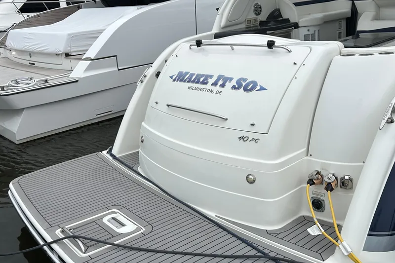 Slide: The Image of 2016 Formula 40 Cruiser yacht docked, rear view with "Make It So" nameplate. - 8