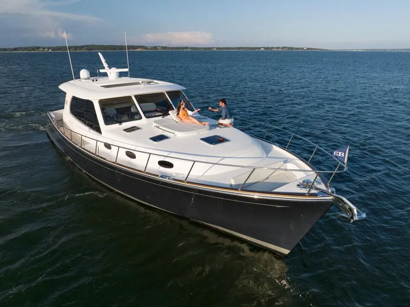 Slide: The Image of Eastbay EB60 yacht cruising at sunset, 2023 model, serene ocean view. - 13