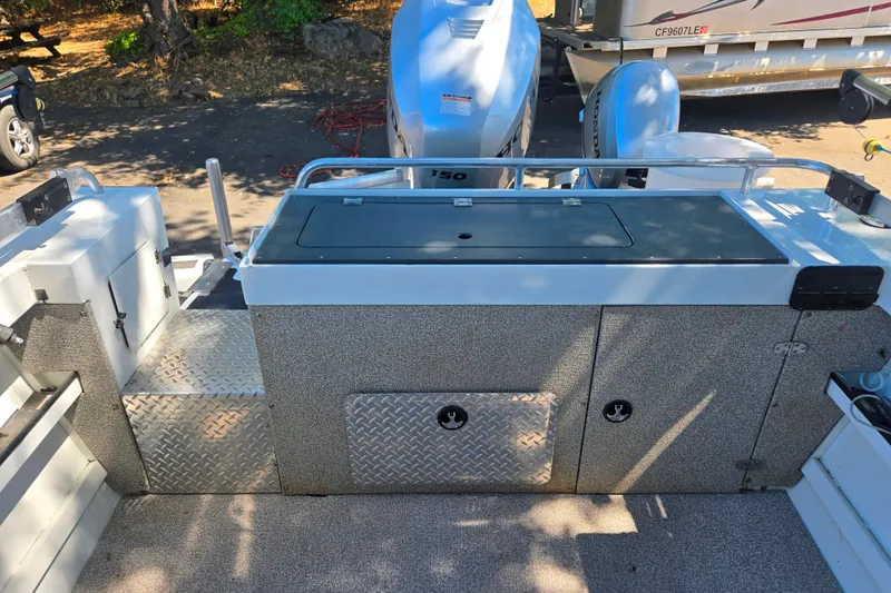 Slide: The Image of 2021 Raider 210.Explorer boat deck with storage compartments and outboard motor. - 17