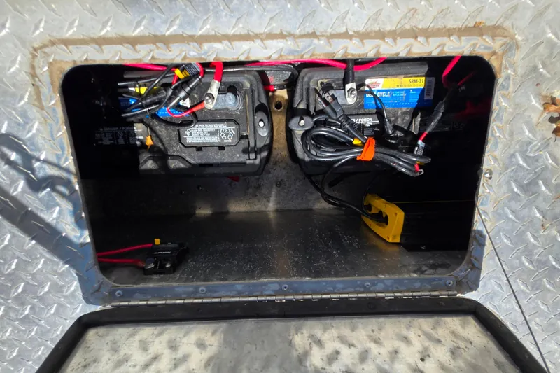 Slide: The Image of Battery compartment of 2021 Raider 210.Explorer with wiring and connections. - 19