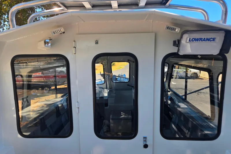 Slide: The Image of 2021 Raider 210.Explorer boat cabin with Lowrance equipment, exterior view. - 23