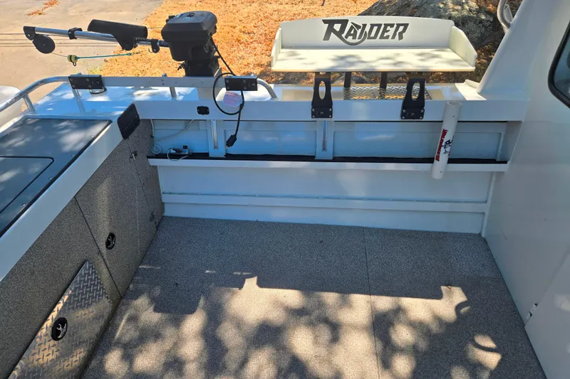 Slide: The Image of Interior of a 2021 Raider 210.Explorer boat with fishing equipment and storage compartments. - 24