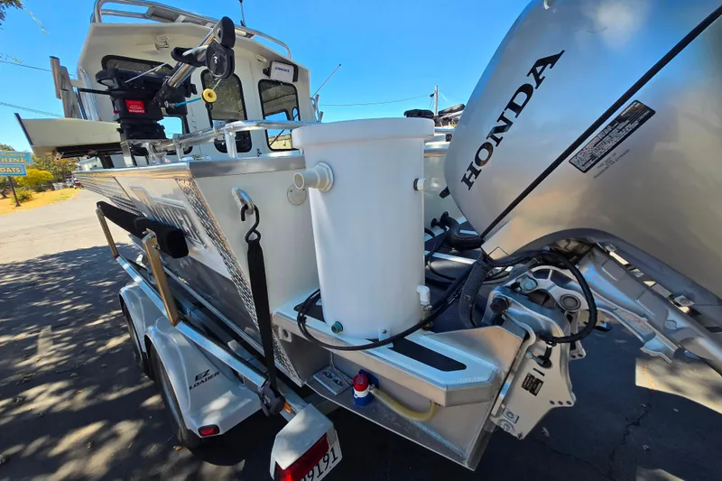 Slide: The Image of 2021 Raider 210.Explorer boat with Honda outboard motor on trailer. - 3