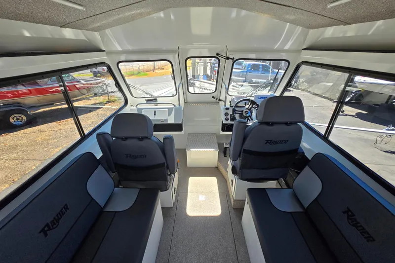Slide: The Image of Interior of 2021 Raider 210.Explorer boat with seating and steering console. - 6