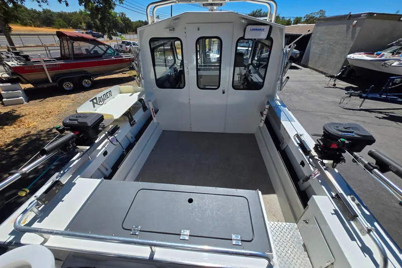 Slide: The Image of 2021 Raider 210.Explorer boat interior with fishing equipment and storage compartments. - 8