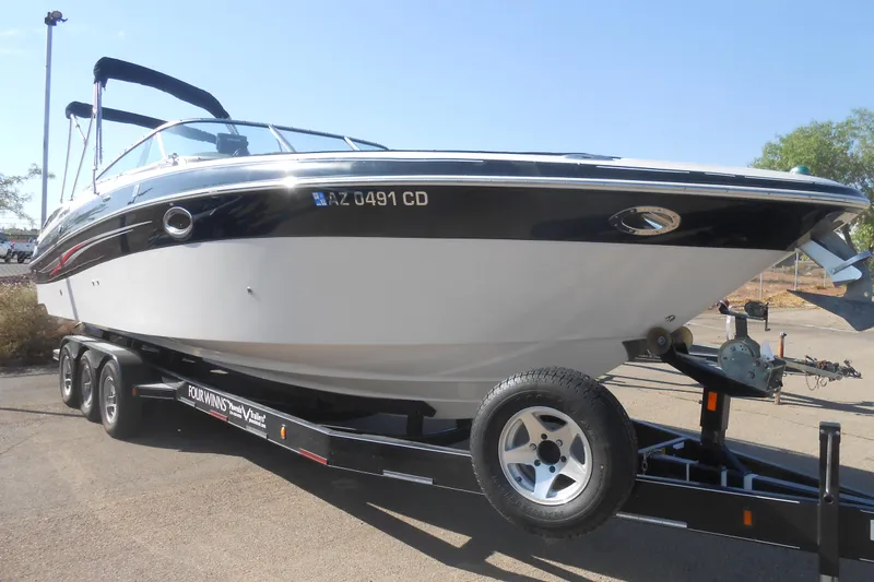 Slide: The Image of 2008 Four Winns H Series H310 boat interior with white seating and dashboard. - 5