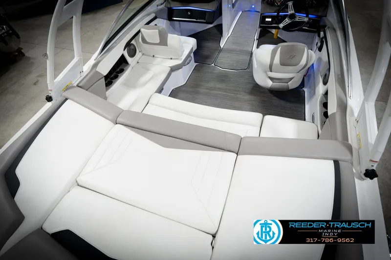 Slide: The Image of 2020 Four Winns H210 boat interior with white seating and modern dashboard. - 13