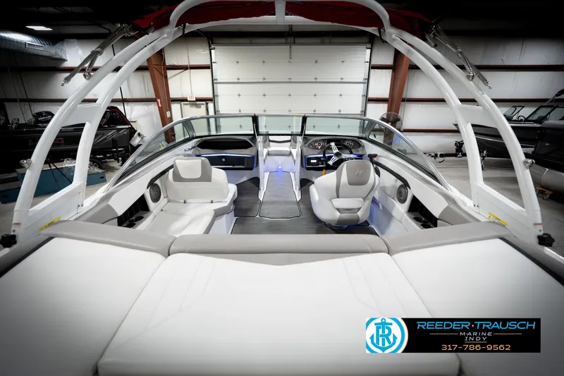 Slide: The Image of 2020 Four Winns H210 boat interior with modern seating and dashboard in showroom. - 15