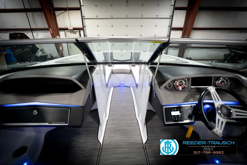 Slide: The Image of Interior view of 2020 Four Winns H210 boat with modern dashboard and steering wheel. - 16