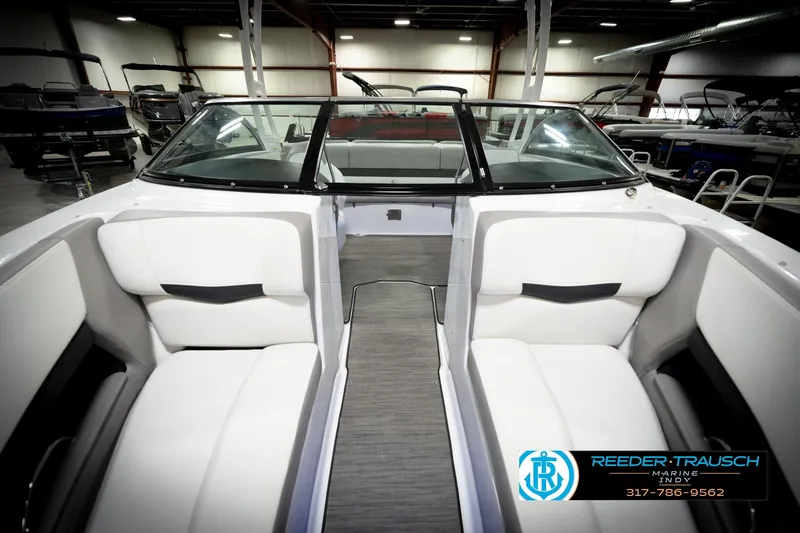 Slide: The Image of 2020 Four Winns H210 boat interior with white seating in showroom. - 18