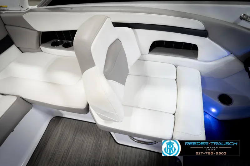 Slide: The Image of Interior seating of 2020 Four Winns H210 boat with white upholstery and cup holders. - 23