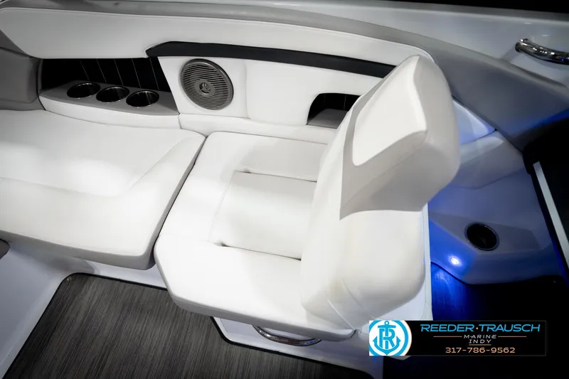 Slide: The Image of Interior of 2020 Four Winns H210 boat with white seating and cup holders. - 24