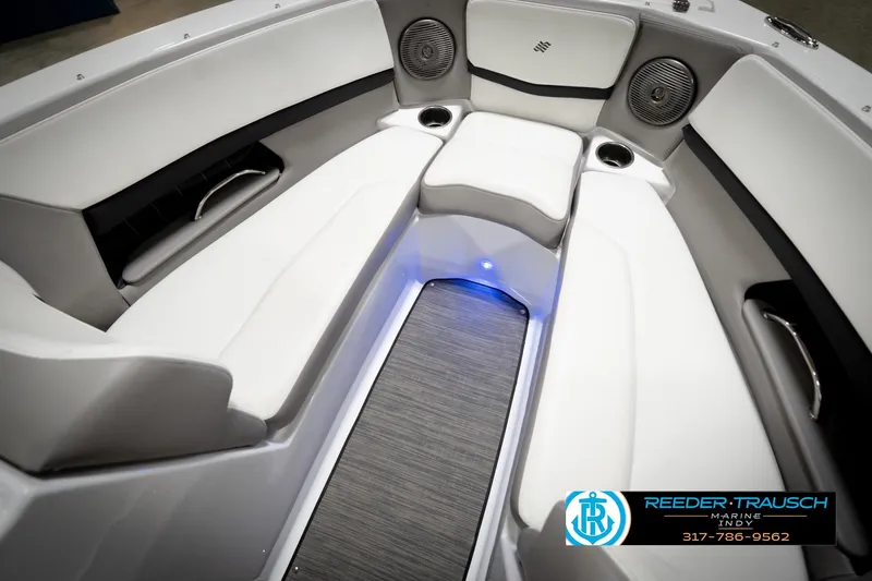 Slide: The Image of Interior of 2020 Four Winns H210 boat with white seating and blue LED lighting. - 25