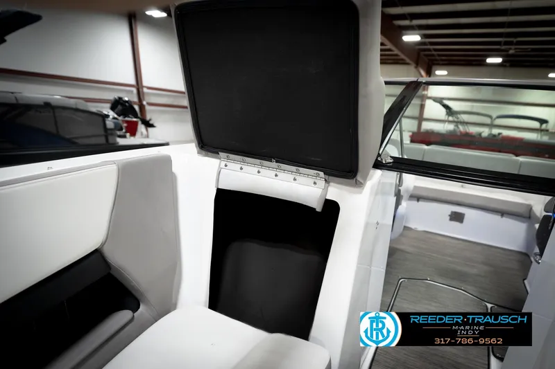 Slide: The Image of 2020 Four Winns H210 boat interior with seating and storage compartment. - 28