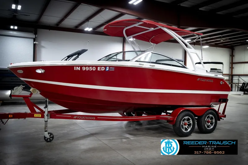 Slide: The Image of 2020 Four Winns H210 red boat on trailer in indoor showroom. - 3