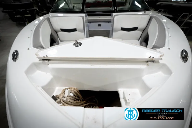 Slide: The Image of 2020 Four Winns H210 boat interior with open storage compartment and seating. - 30