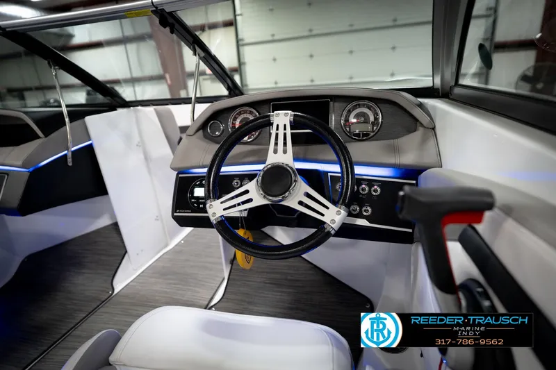 Slide: The Image of Interior view of 2020 Four Winns H210 boat dashboard with steering wheel and controls. - 31