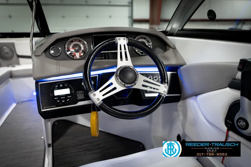 Slide: The Image of 2020 Four Winns H210 boat dashboard with steering wheel and control panel. - 32