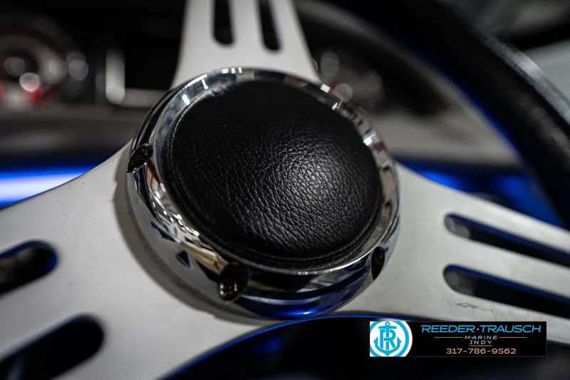 Slide: The Image of Close-up of 2020 Four Winns H210 steering wheel with chrome and leather details. - 33