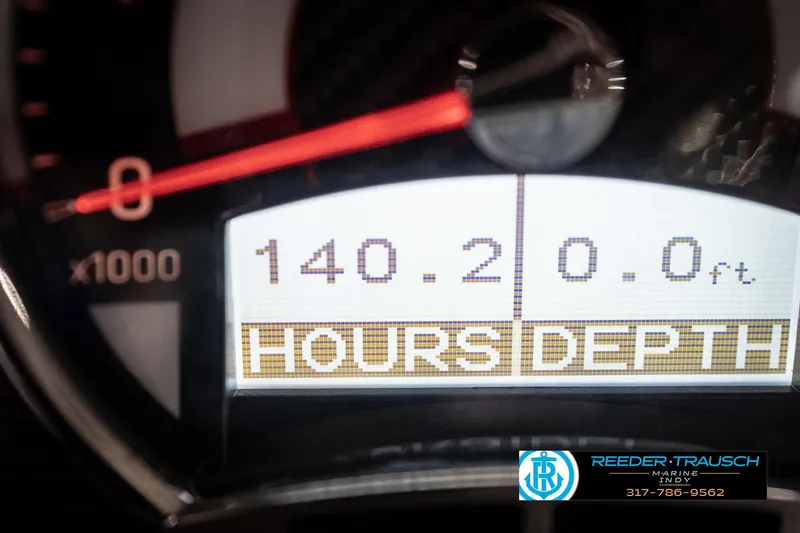 Slide: The Image of Close-up of a 2020 Four Winns H210 boat dashboard displaying hours and depth. - 37