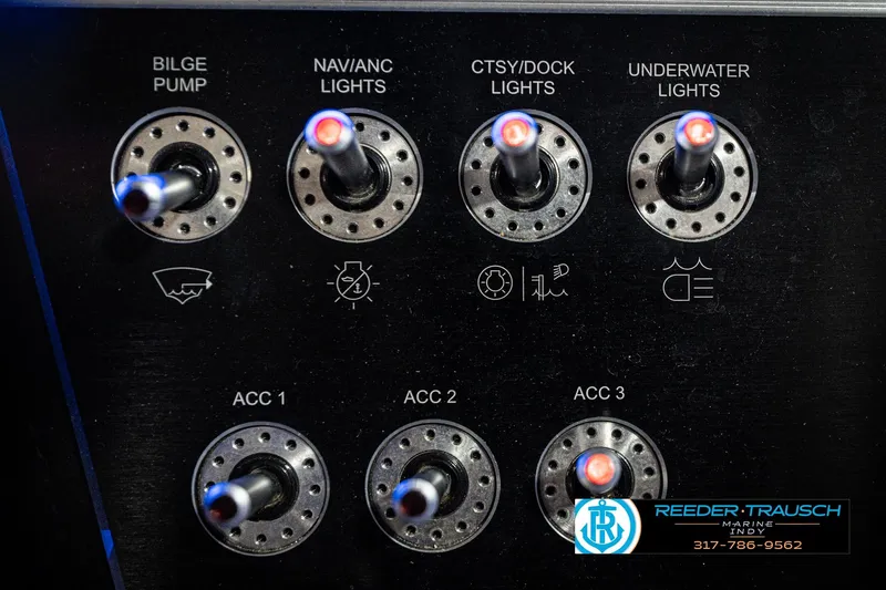 Slide: The Image of Control panel of a 2020 Four Winns H210 boat with labeled switches. - 38