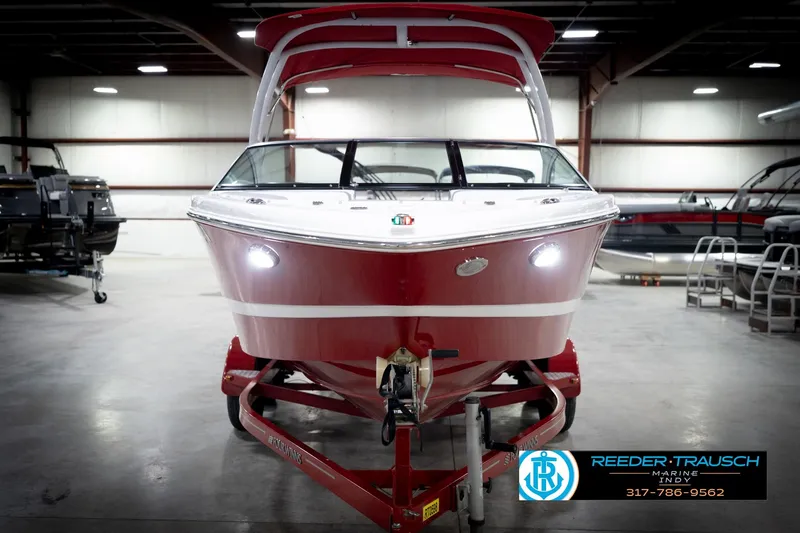 Slide: The Image of 2020 Four Winns H210 boat in showroom, red hull, on trailer, Reeder Trausch Marine. - 4