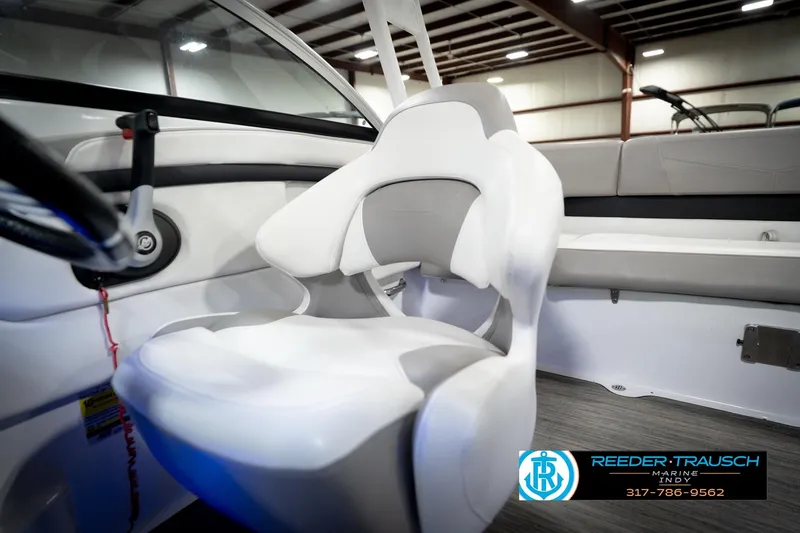 Slide: The Image of Interior of 2020 Four Winns H210 boat featuring a sleek white captain's chair. - 40