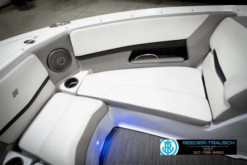 Slide: The Image of 2020 Four Winns H210 boat interior with white seating, cup holders, and speaker. - 42