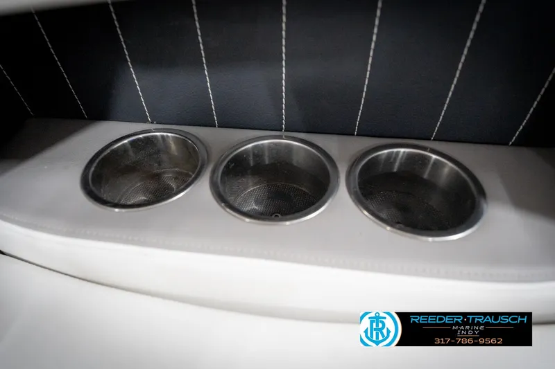 Slide: The Image of Cup holders in a 2020 Four Winns H210 boat interior, featuring sleek design and stitching. - 45