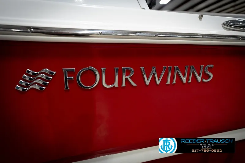 Slide: The Image of Red 2020 Four Winns H210 boat with chrome logo and Reeder-Trausch Marine branding. - 48