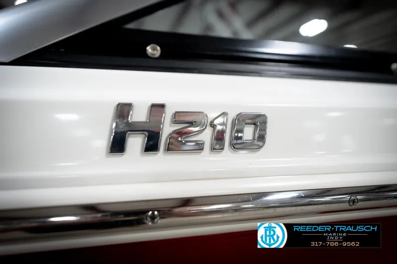 Slide: The Image of 2020 Four Winns H210 boat emblem with Reeder-Trausch Marine logo. - 49