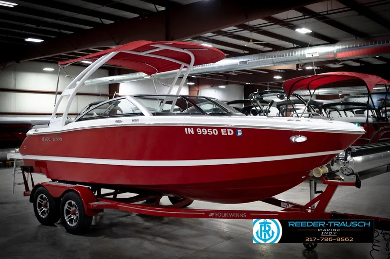 Slide: The Image of 2020 Four Winns H210 red boat on trailer in indoor showroom. - 5