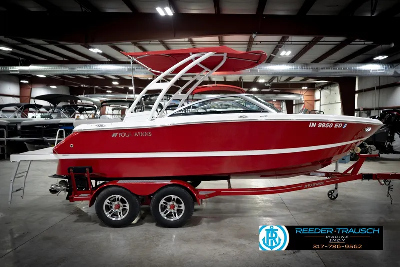 Slide: The Image of 2020 Four Winns H210 red boat on trailer in indoor showroom. - 6