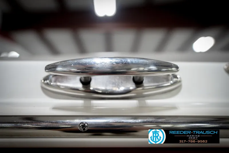 Slide: The Image of Close-up of a 2020 Four Winns H210 boat cleat, showcasing sleek chrome finish. - 60