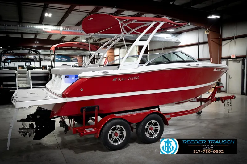 Slide: The Image of 2020 Four Winns H210 red boat on trailer in indoor showroom. - 7