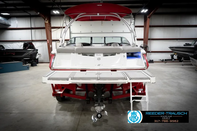 Slide: The Image of 2020 Four Winns H210 boat in showroom, rear view with swim platform and ladder. - 8