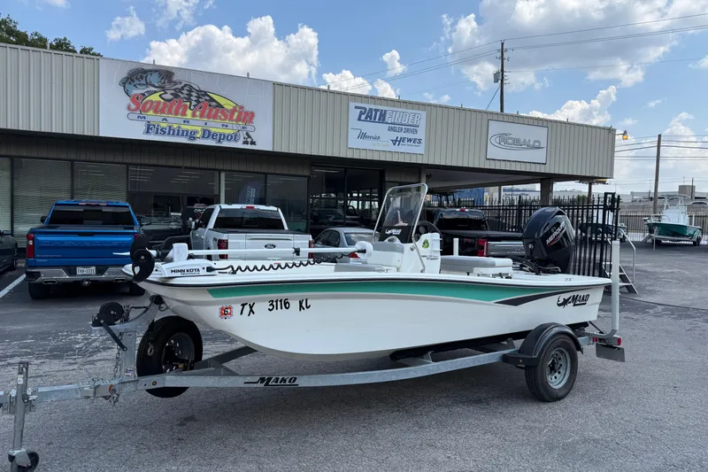 The Image of 2022 Mako Pro Skiff 15 CC boat on trailer outside South Austin Marine store. - 1