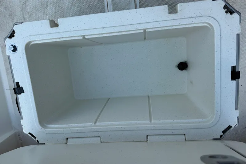 Slide: The Image of Open storage compartment in 2022 Mako Pro Skiff 15 CC boat. - 10