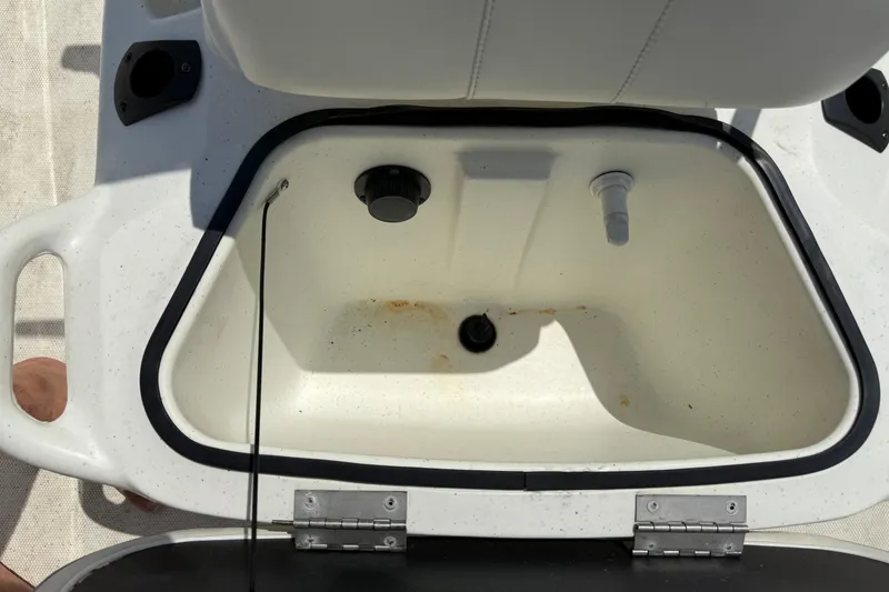 Slide: The Image of Open storage compartment on a 2022 Mako Pro Skiff 15 CC boat. - 15