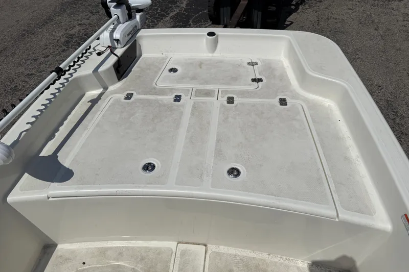 Slide: The Image of 2022 Mako Pro Skiff 15 CC boat deck with storage compartments and trolling motor. - 16