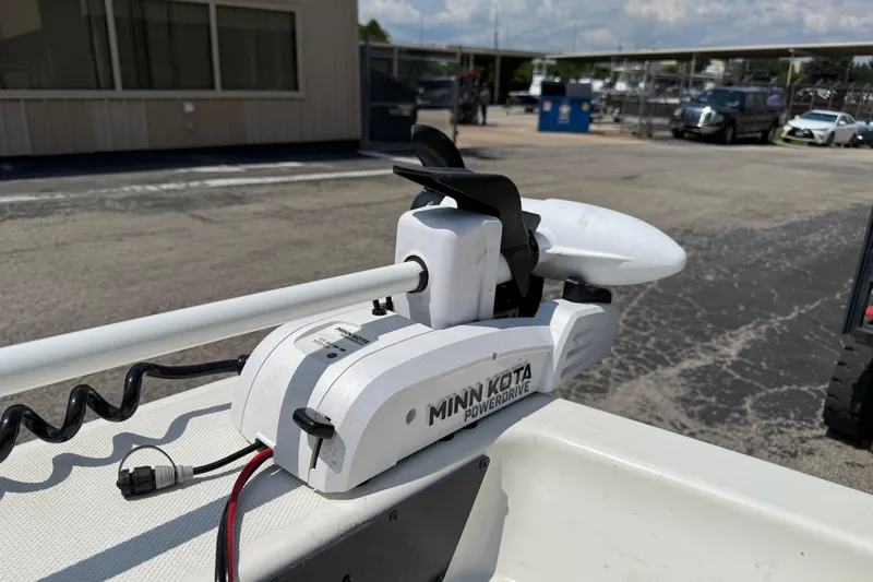 Slide: The Image of Minn Kota PowerDrive motor on 2022 Mako Pro Skiff 15 CC boat, parked outdoors. - 19