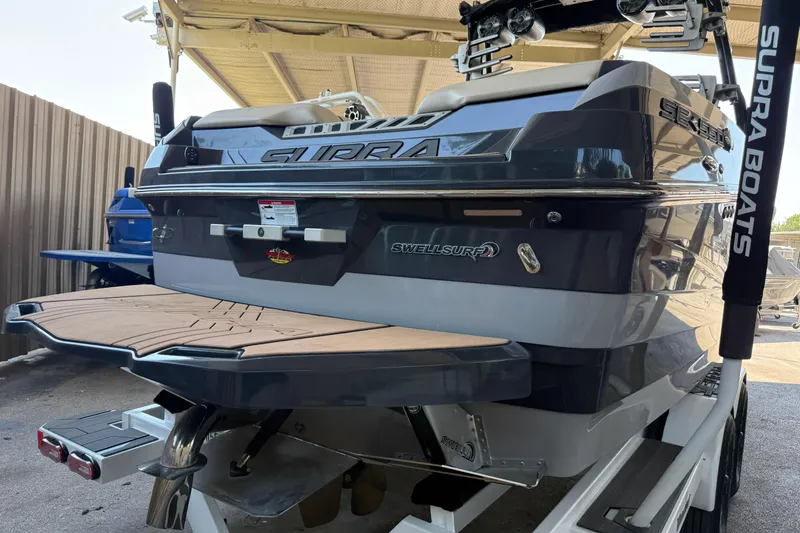 Slide: The Image of 2019 Supra SE 550 boat with SwellSurf technology, rear view in a covered area. - 3