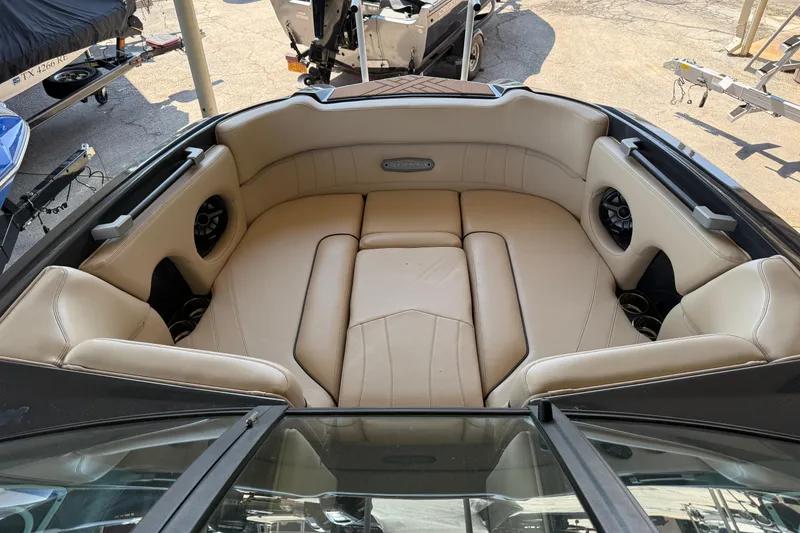 Slide: The Image of 2019 Supra SE 550 boat interior with beige leather seating and built-in speakers. - 4