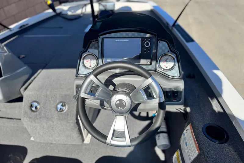 Slide: The Image of 2023 G3 SPORTSMAN 170 boat dashboard with steering wheel and navigation display. - 19