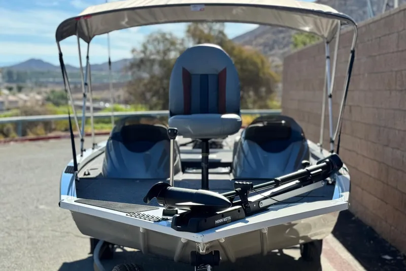 Slide: The Image of 2023 G3 SPORTSMAN 170 boat with canopy and Minn Kota trolling motor. - 2