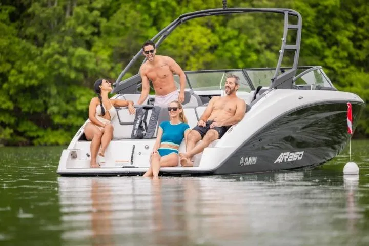 Slide: The Image of 2026 Yamaha Boats AR250 with people enjoying a sunny day on the water. - 2