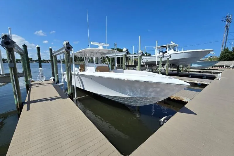Slide: The Image of 2025 Bahama 35 boat docked at marina under clear blue sky. - 2