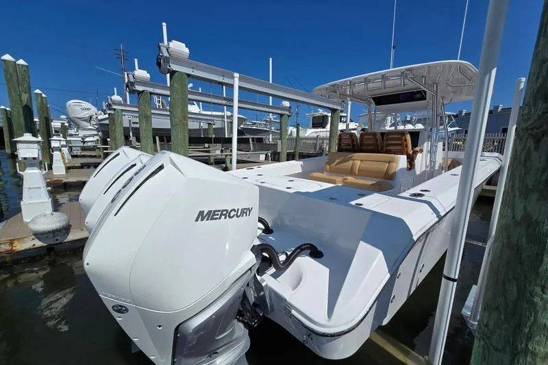 Slide: The Image of 2025 Bahama 35 boat with Mercury engines docked at marina. - 3